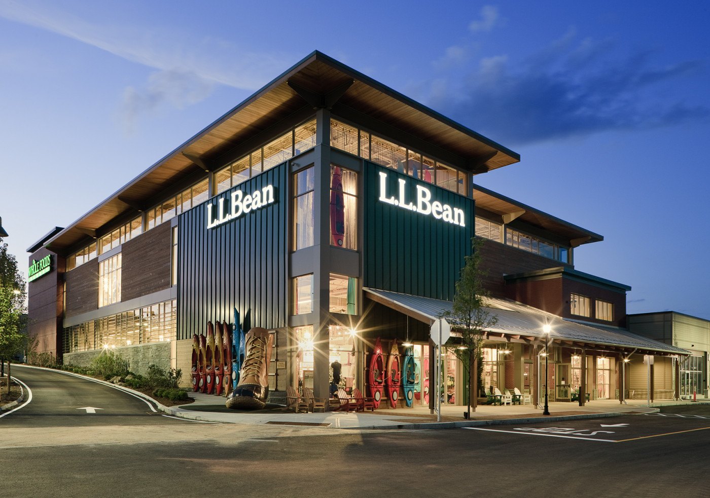 L.L.Bean Hanover store at dusk, with metal panel, wood-tone siding and a timber roof overhang