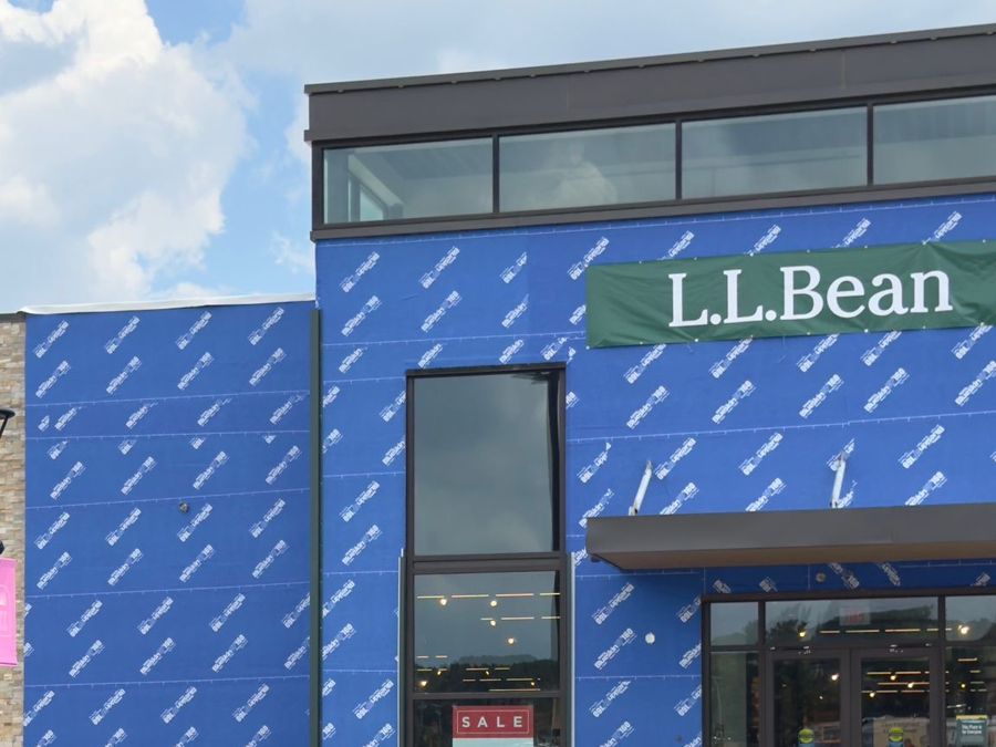 Retail storefront wrapped in blue air and water barrier before cladding