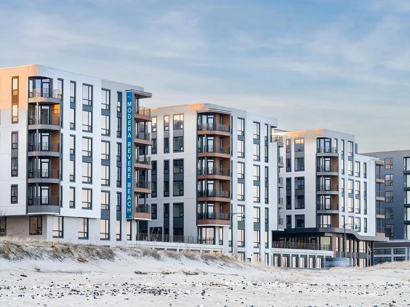 Residential buildings with a light panel facade and balconies facing Revere Beach